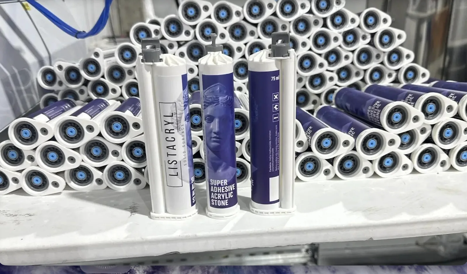 Three LISTACRYL Super Adhesive Acrylic Stone cartridges on the bench in front of a finished batch